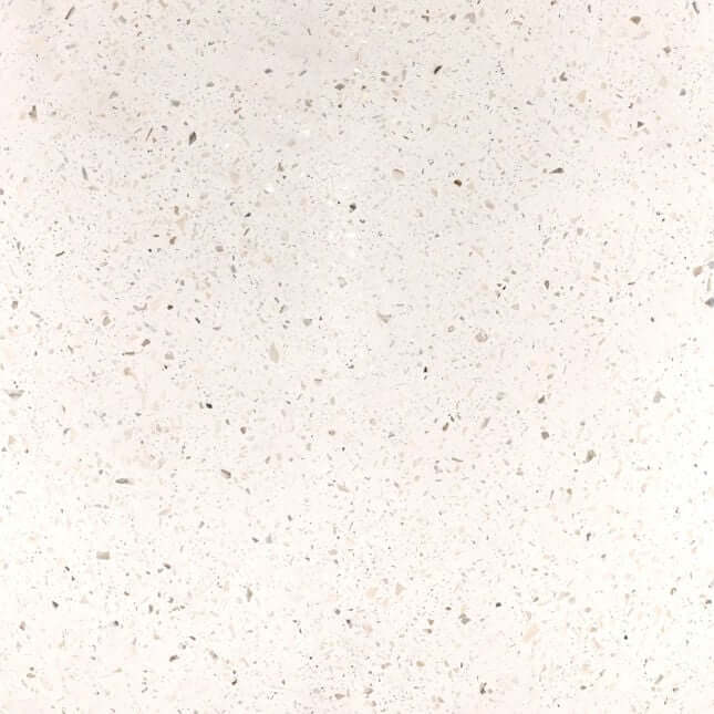 Close-up of a textured white surface with small specks