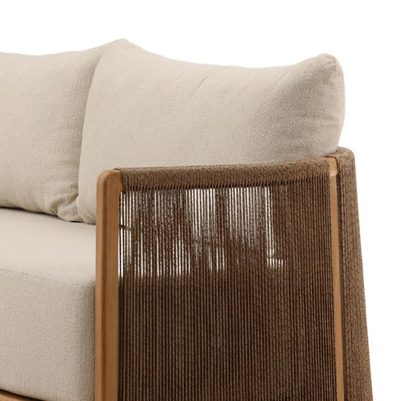 Close-up of a beige sofa with a woven brown armrest on a white background