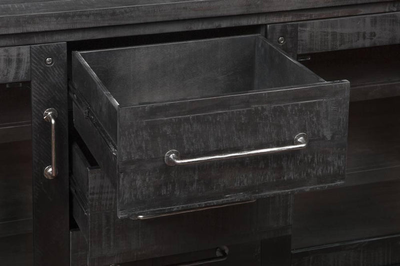 Black metal drawer with handle on a dark wooden surface
