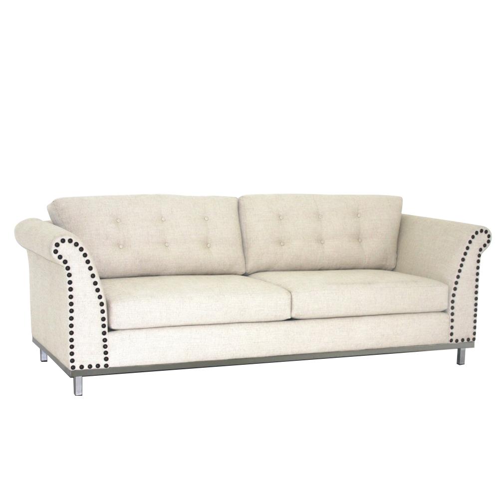 Beige sofa with nailhead trim on a white background