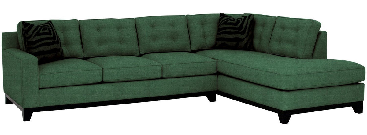 Green sectional sofa with black cushions on a white background