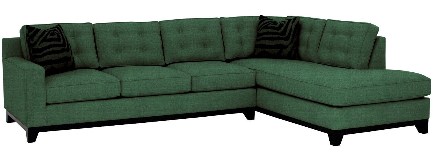 Green sectional sofa with black cushions on a white background